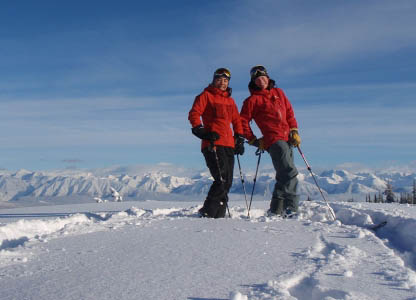 Great Canadian Heli-Skiing guide Alison Dakin with friend checking out our tenure. Photo by Alison Dakin.
