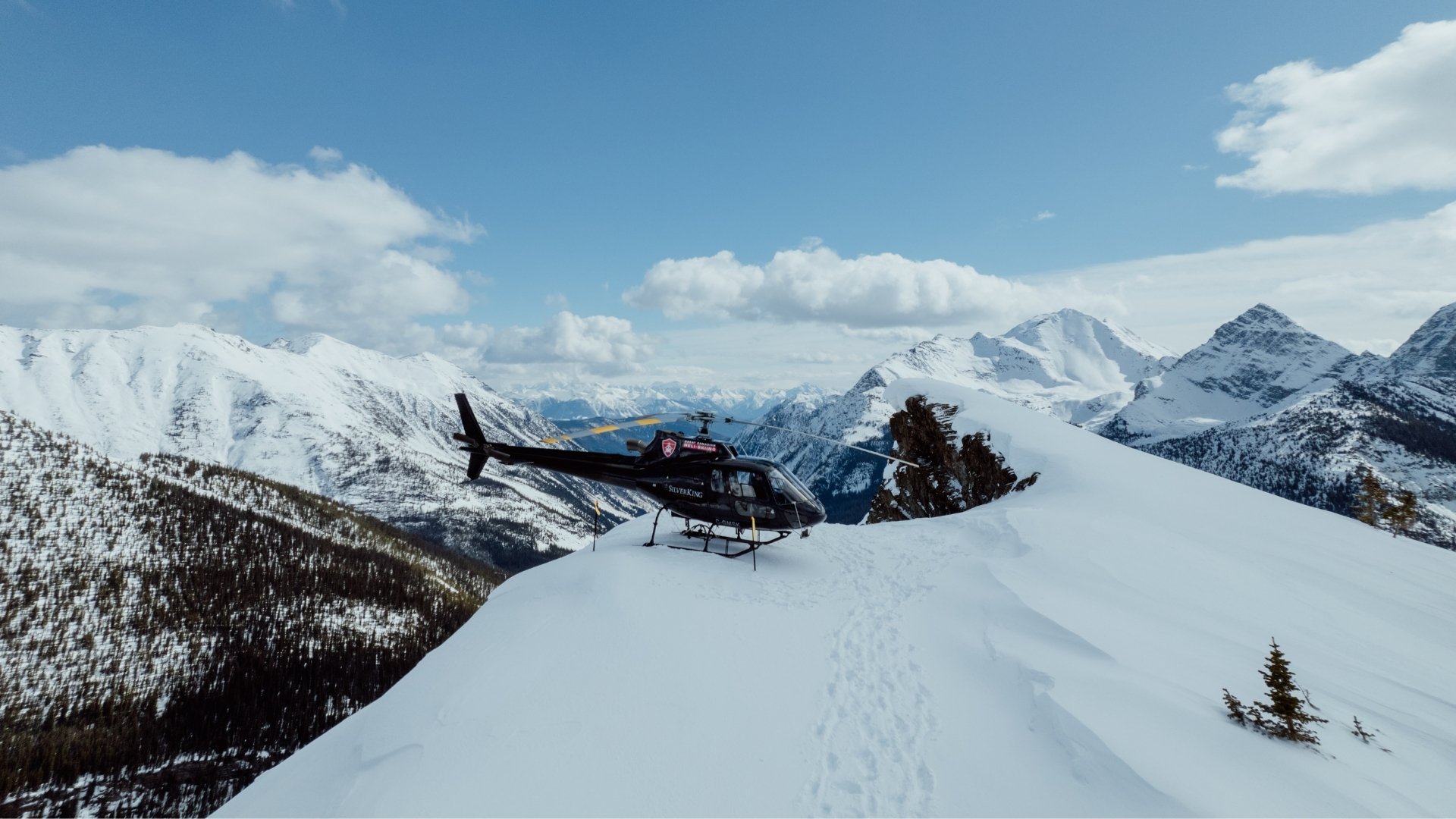Helicopter parked on snowy ridge in British Columbia
