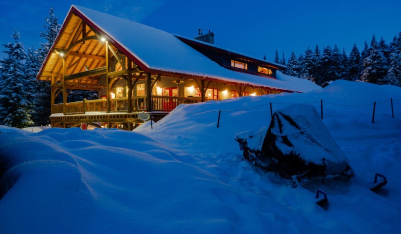 Snowy cabin at night