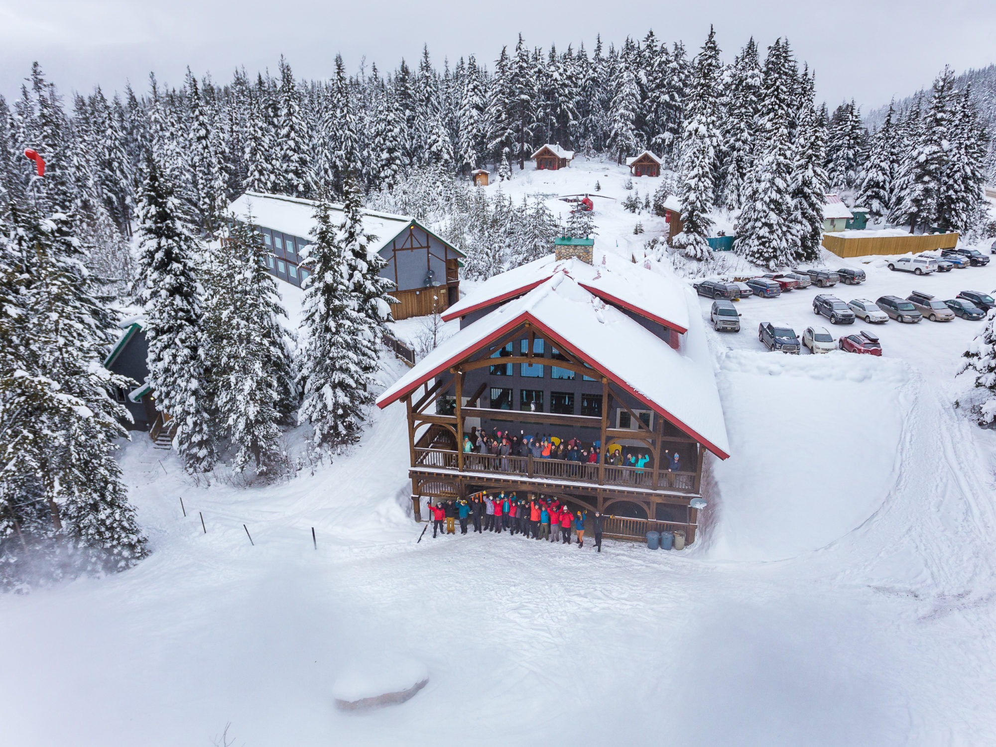 Aerial view of Heather Mountain Lodge with large group of guests waving