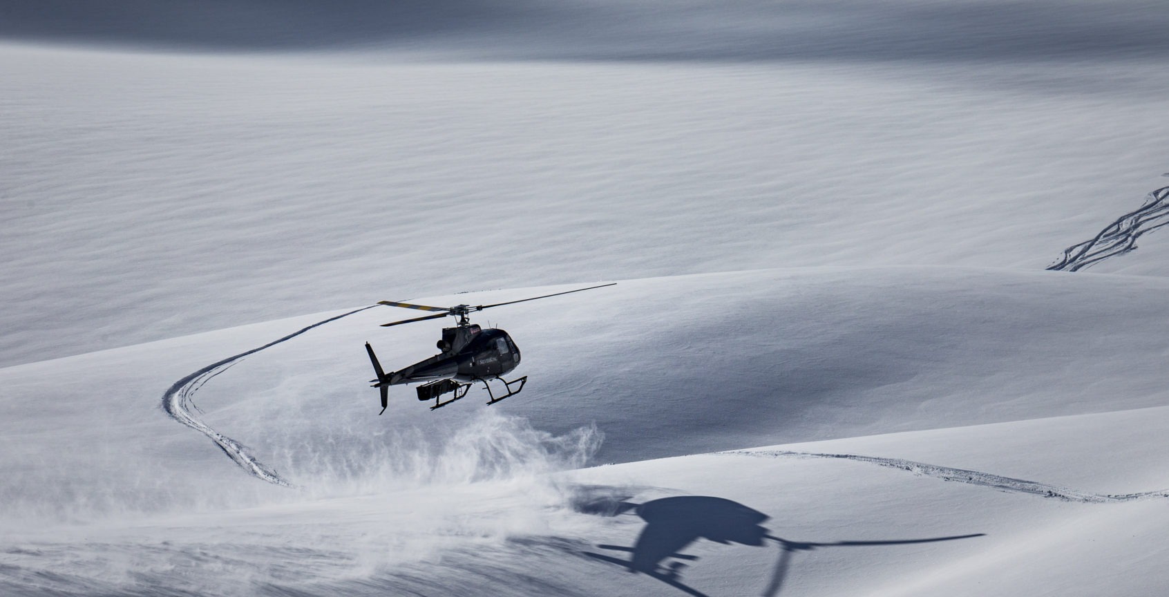 helicopter landing in fresh powder