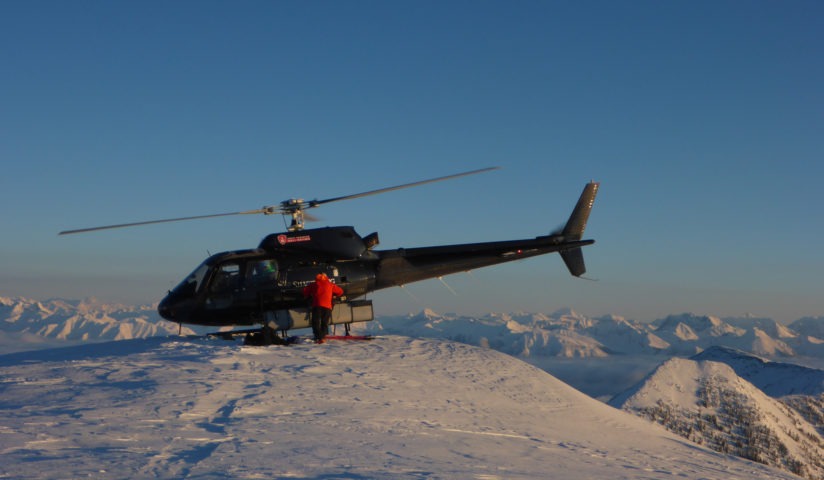 Helicopter on top of mountain for heliskiing