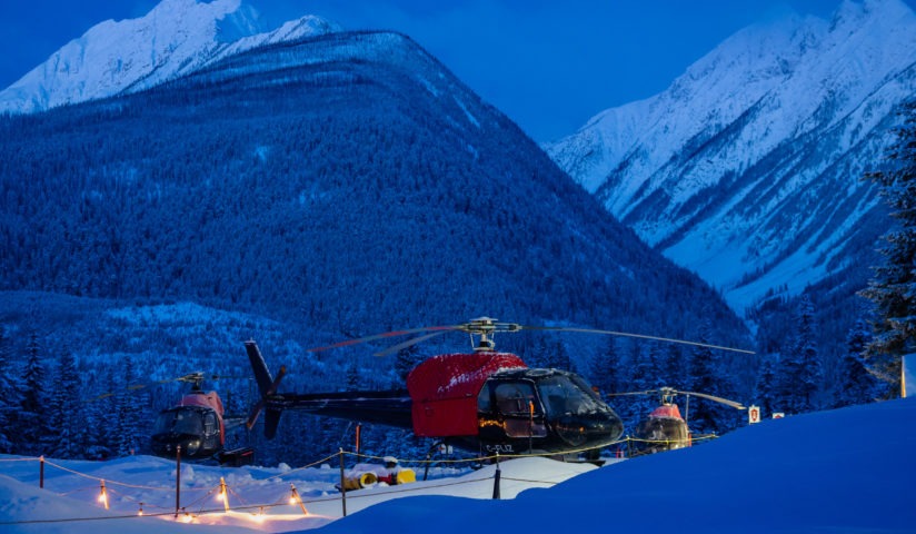 Mountains and helicopter in powder snow