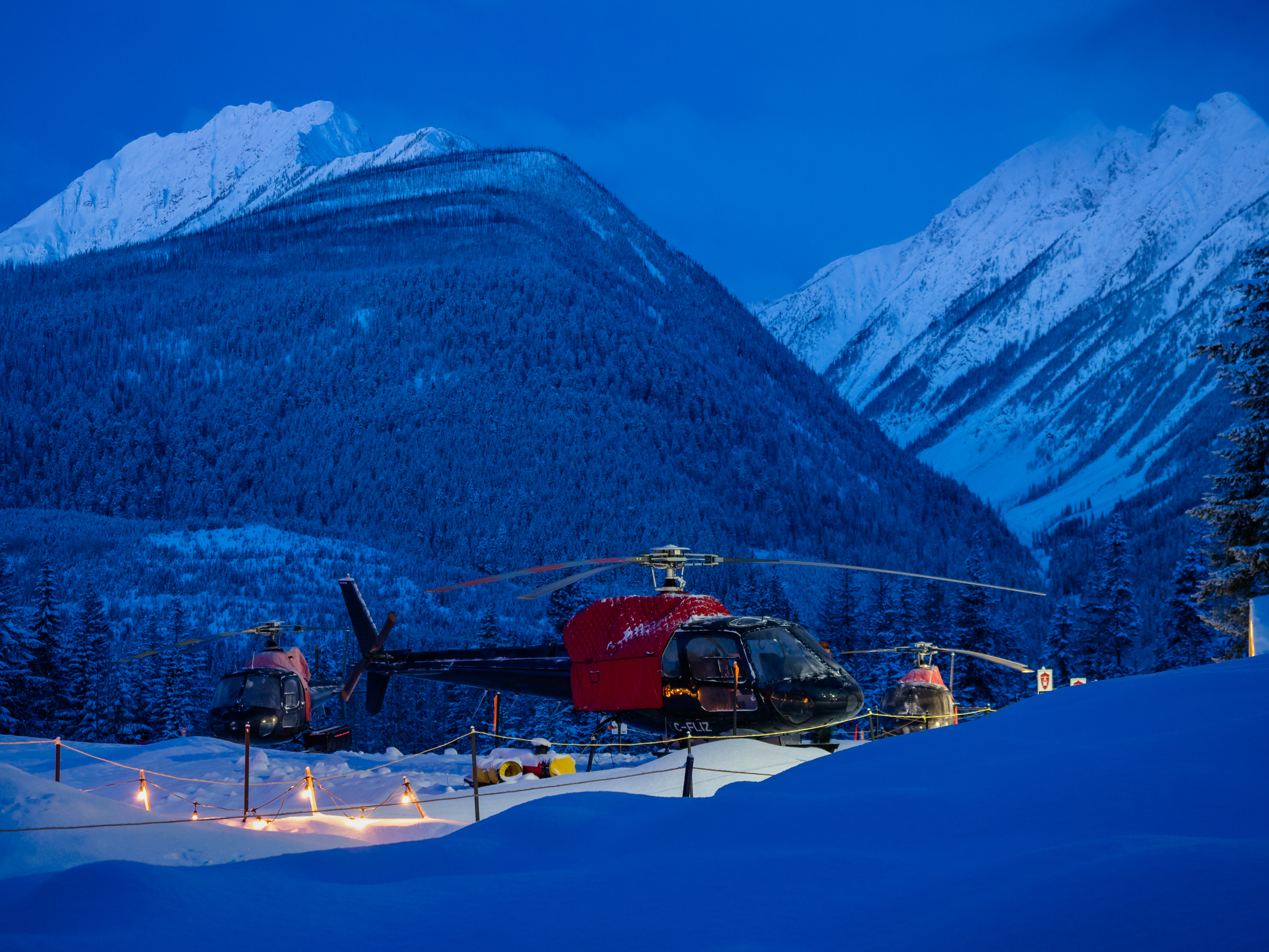 Mountains and helicopter in powder snow