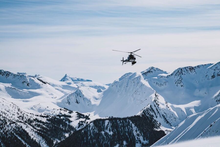Helicopter slinging sleds into the remote backcountry of British Columbia.